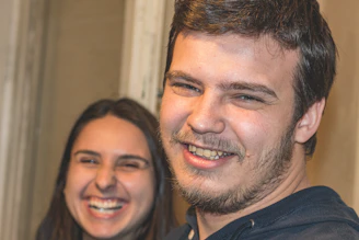 A familiar support worker sharing a warm smile with a client in their living room.