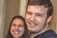 Close-up of satisfied clients sharing smiles while reviewing services in a cozy indoor setting.
