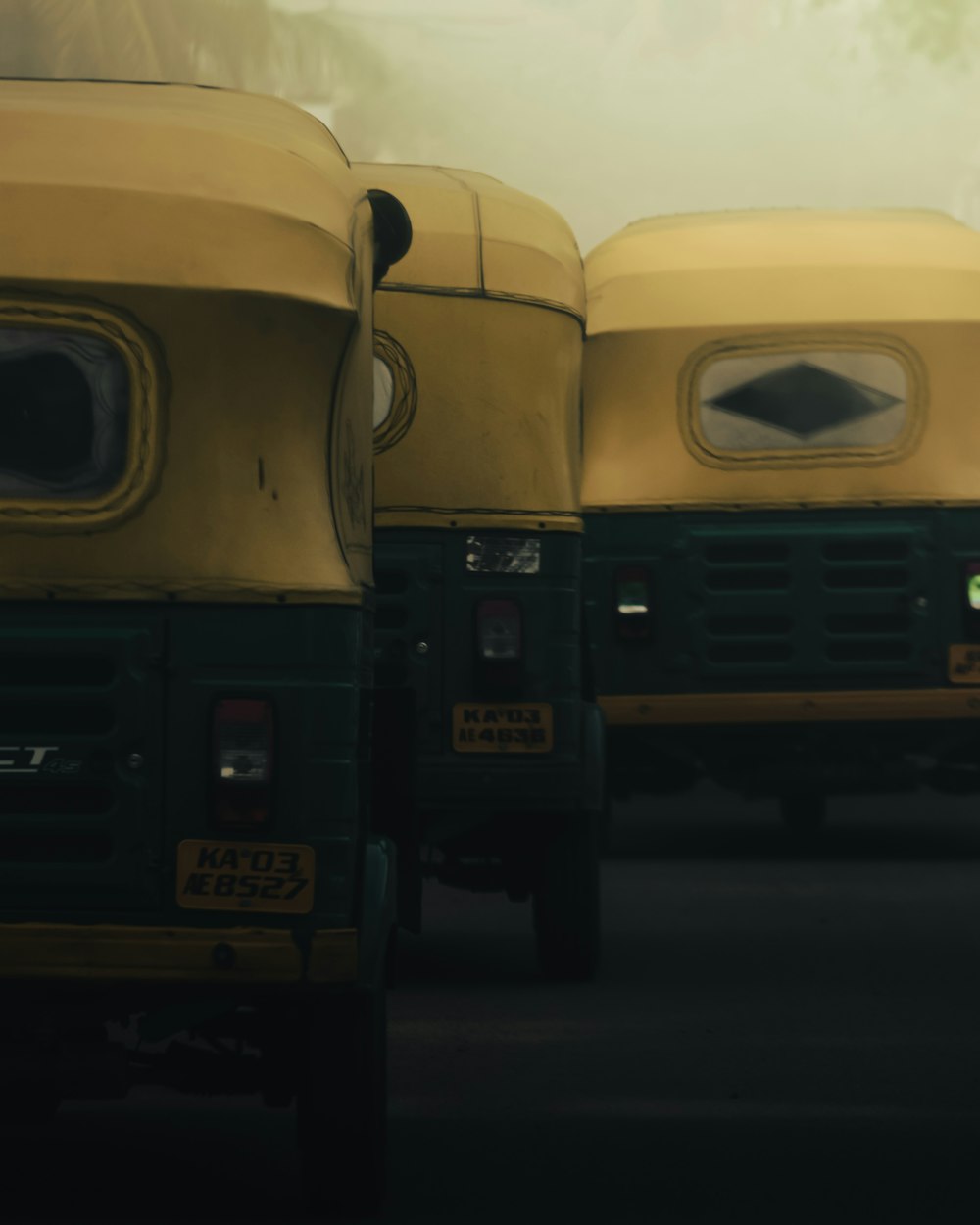 three yellow auto-rickshaws