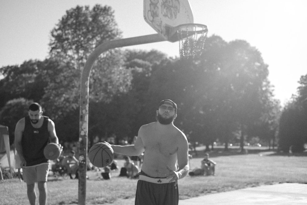 grayscale photography of two men playing basketball