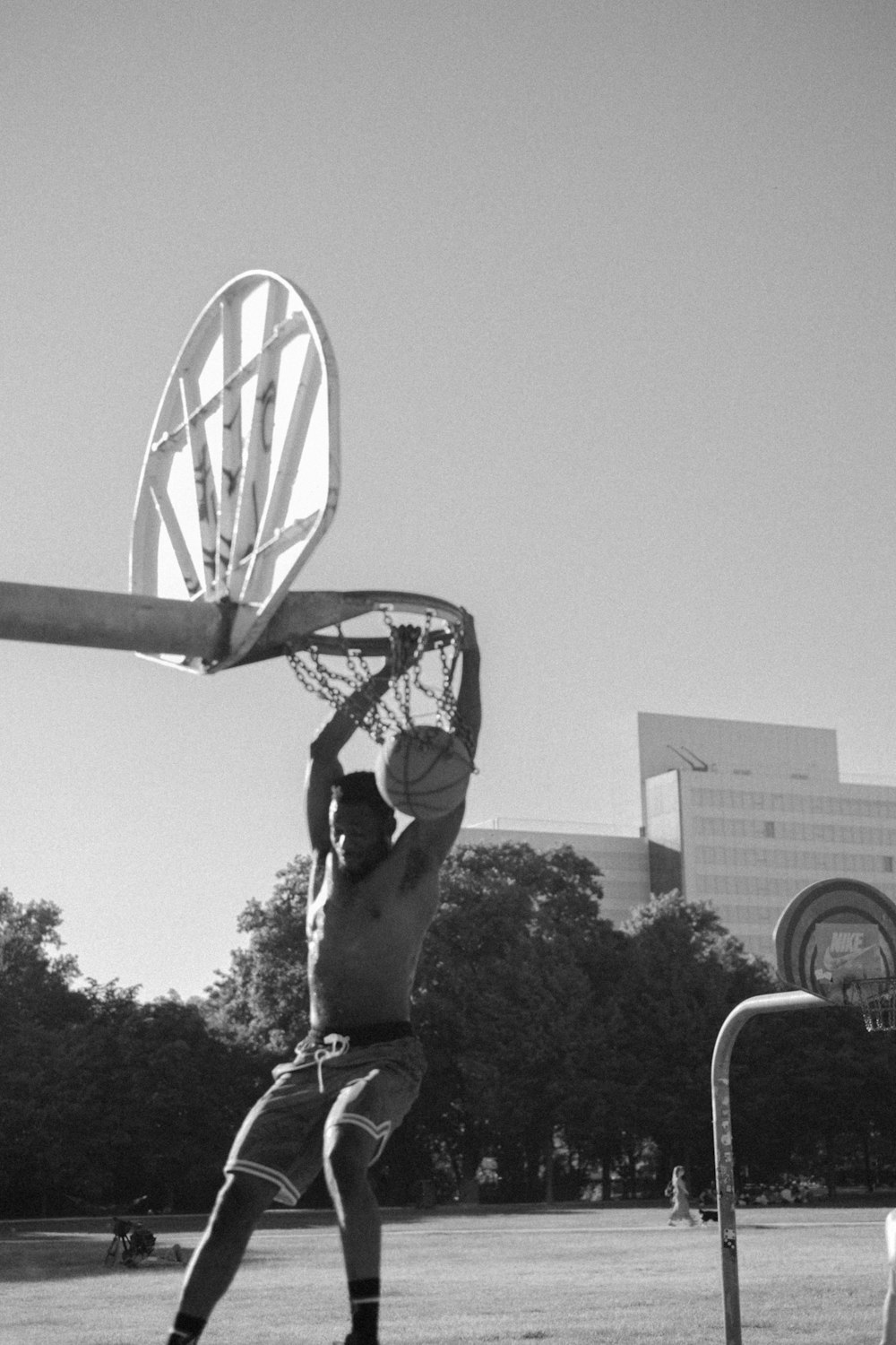 grayscale photography of man playing basketball