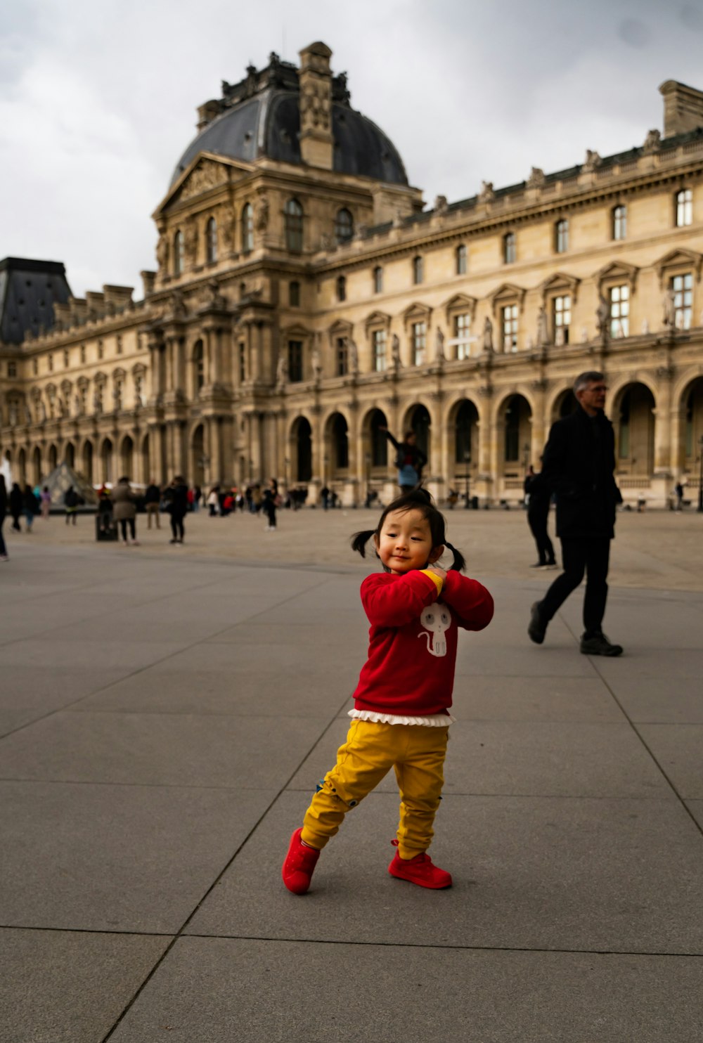 girl standing near brown concrete building