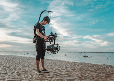 Behind-the-scenes photo of a videomaker filming a tropical beach club.