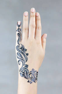 Collection of various henna designs displayed on different skin tones