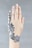A hand with intricately designed henna or temporary tattoo art on the back of it, featuring elaborate black patterns with curving lines and geometric shapes. The skin tone is light, and the nails are unpainted and clean. The background is a plain gray, providing contrast to the detailed design.