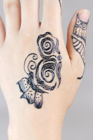 Close-up of intricate mehndi patterns on hands, showcasing delicate artistry.