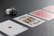 A King of Diamonds playing card is prominently displayed in the foreground on a dark surface, with two red-backed cards beside it. Two dice, one white and one black, are positioned to the left.