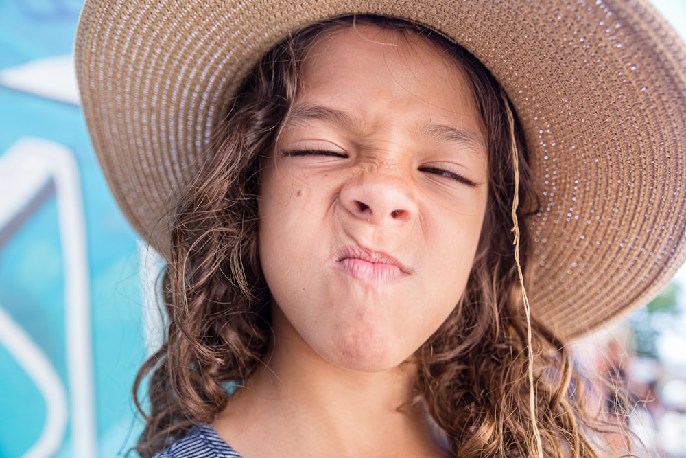 girl wearing brown wicker hat