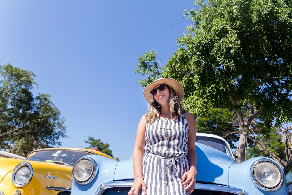 woman standing in front of car