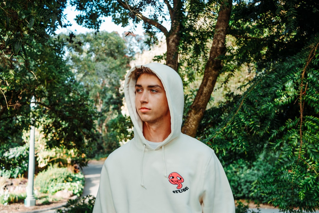 shallow focus photo of man in white pullover hoodie