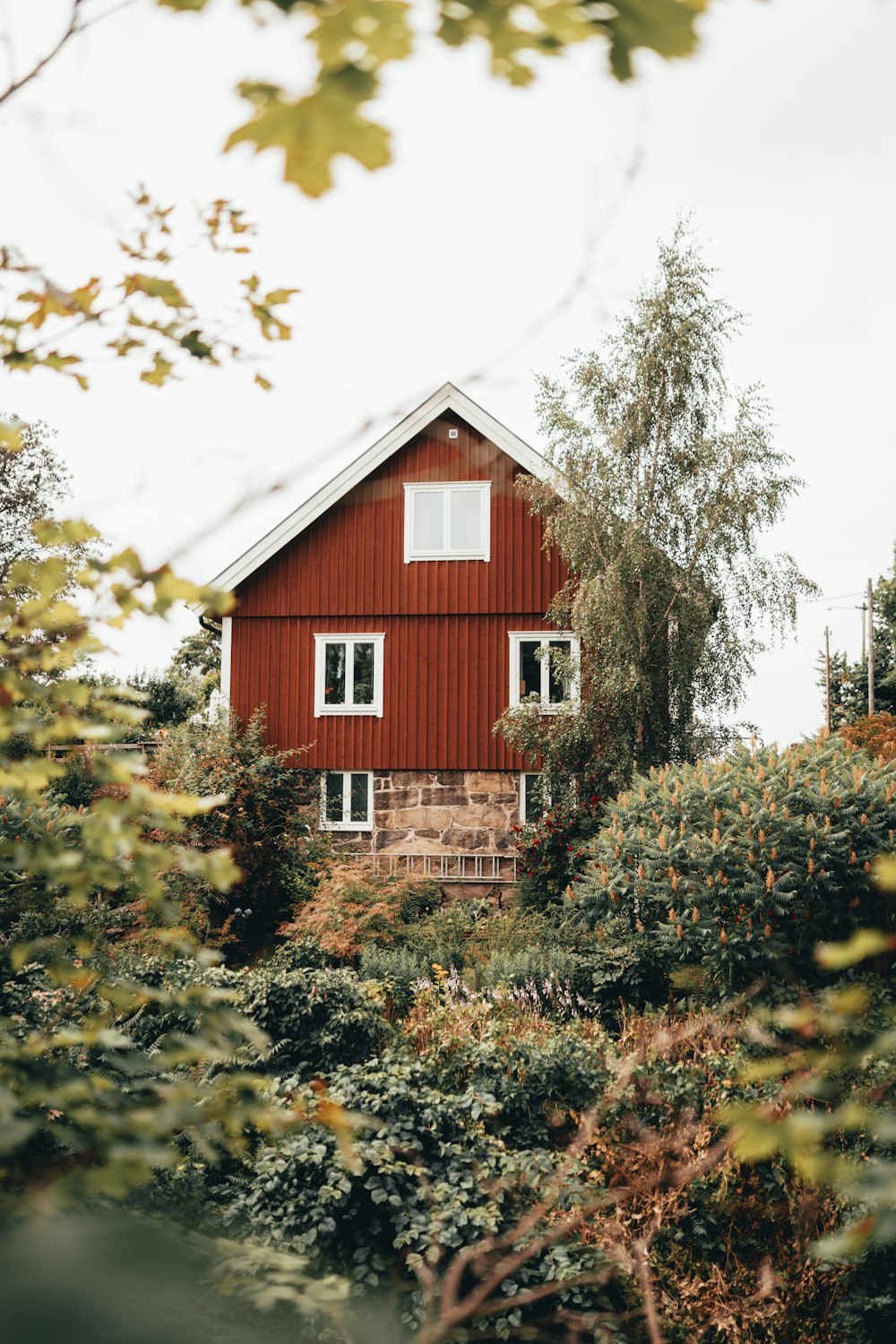 red 3-storey house under white clouds