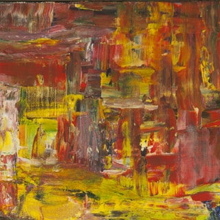 A vibrant painting being loaded into a protective transport case.