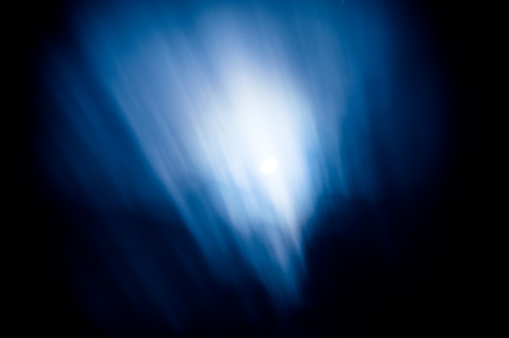 a blurry photo of a bright blue sky
