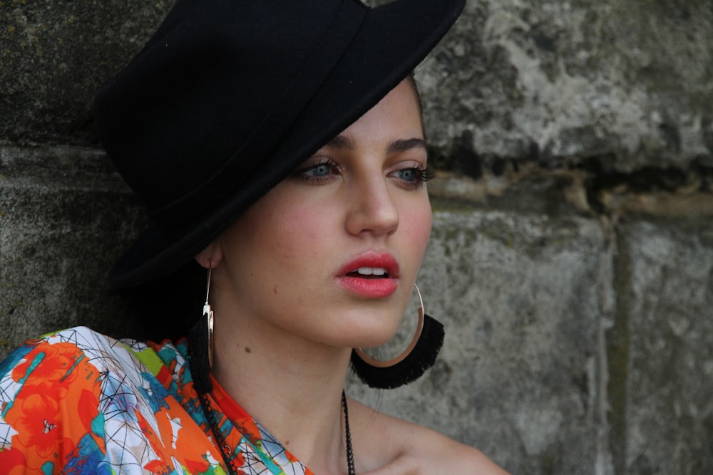 women wearing black hat and multicolored dress close-up photography