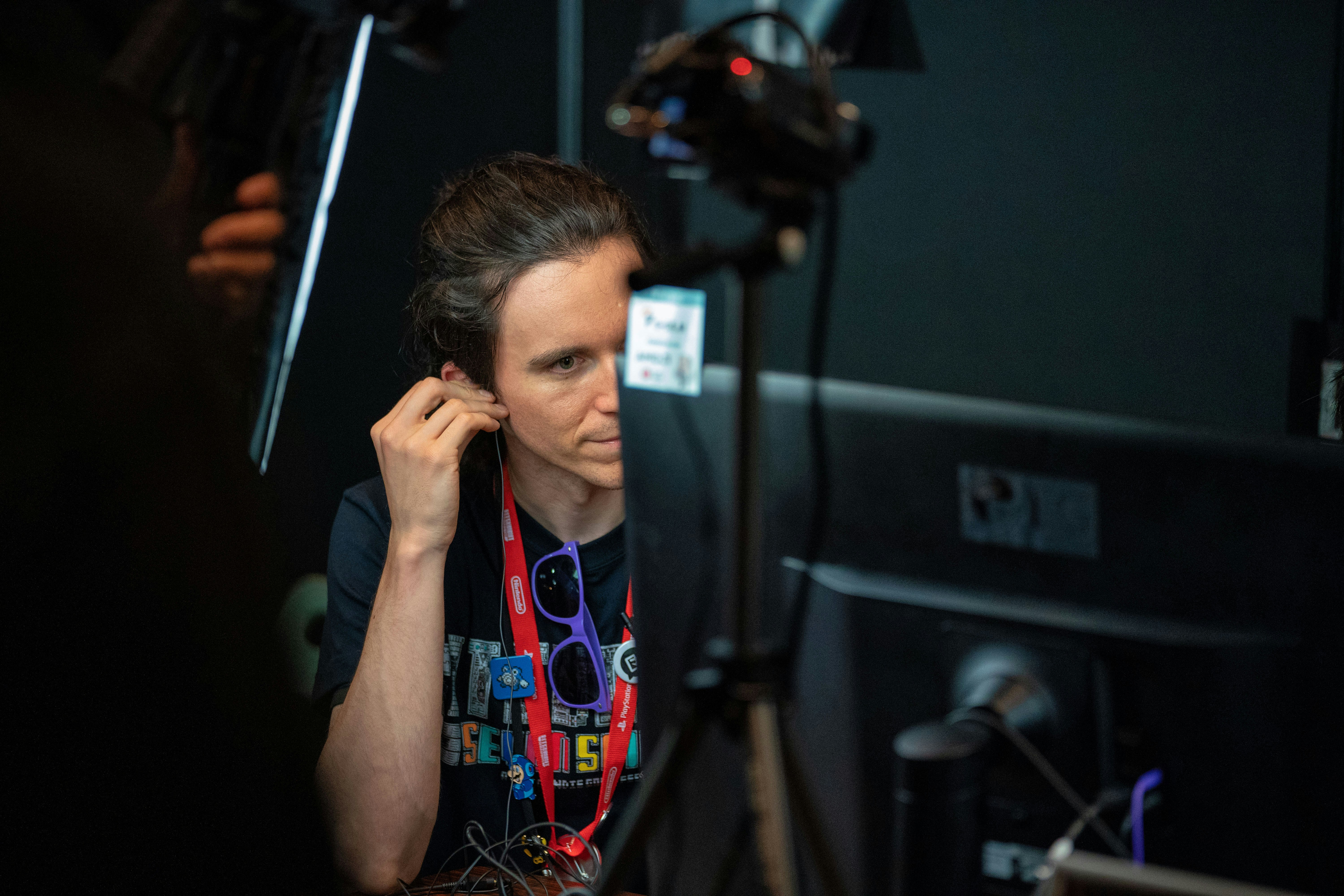 A candid shot of a woman speaking emotionally to a cluster of microphones and cameras, her face conveying distress.