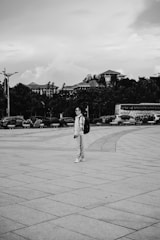 A student with a backpack standing in front of a university campus.
