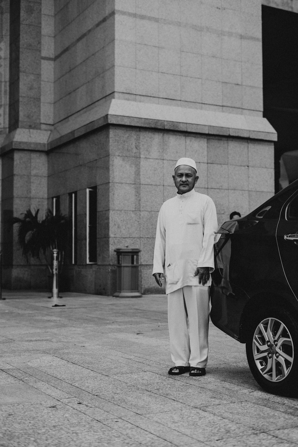 man standing beside vehicle