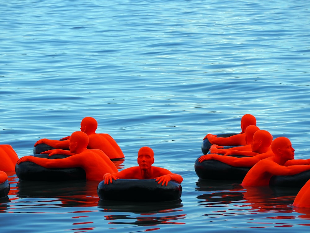 orange men on black stones