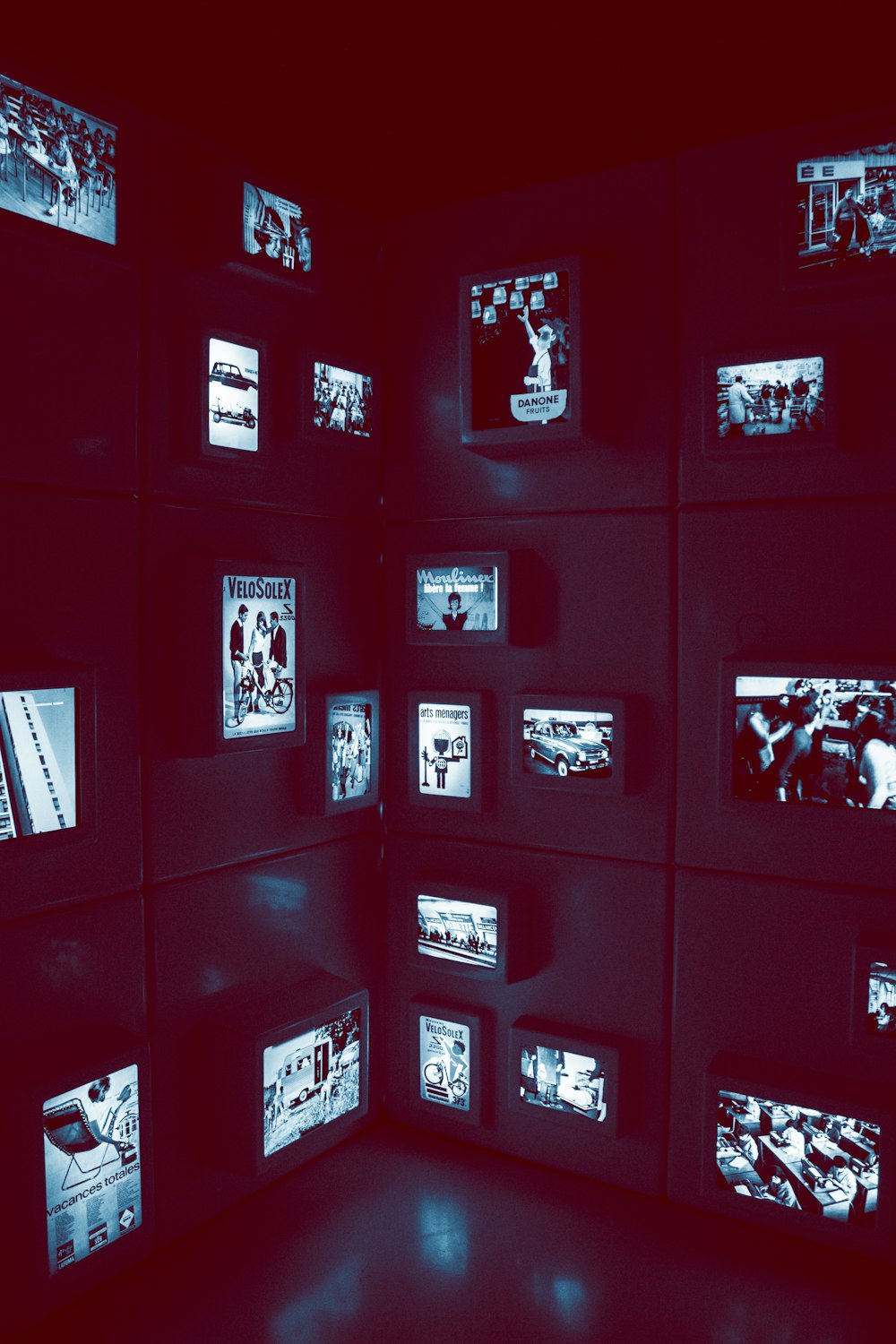 a room with a bunch of televisions on the wall