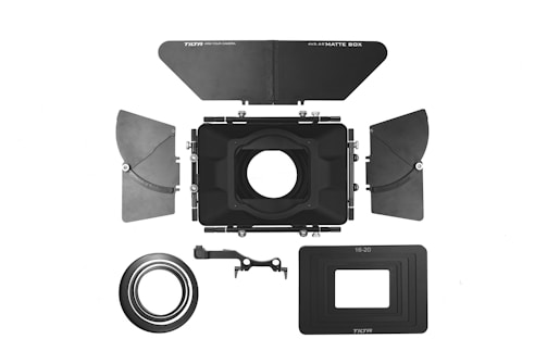 Array of different matte boxes displayed on a wooden table.