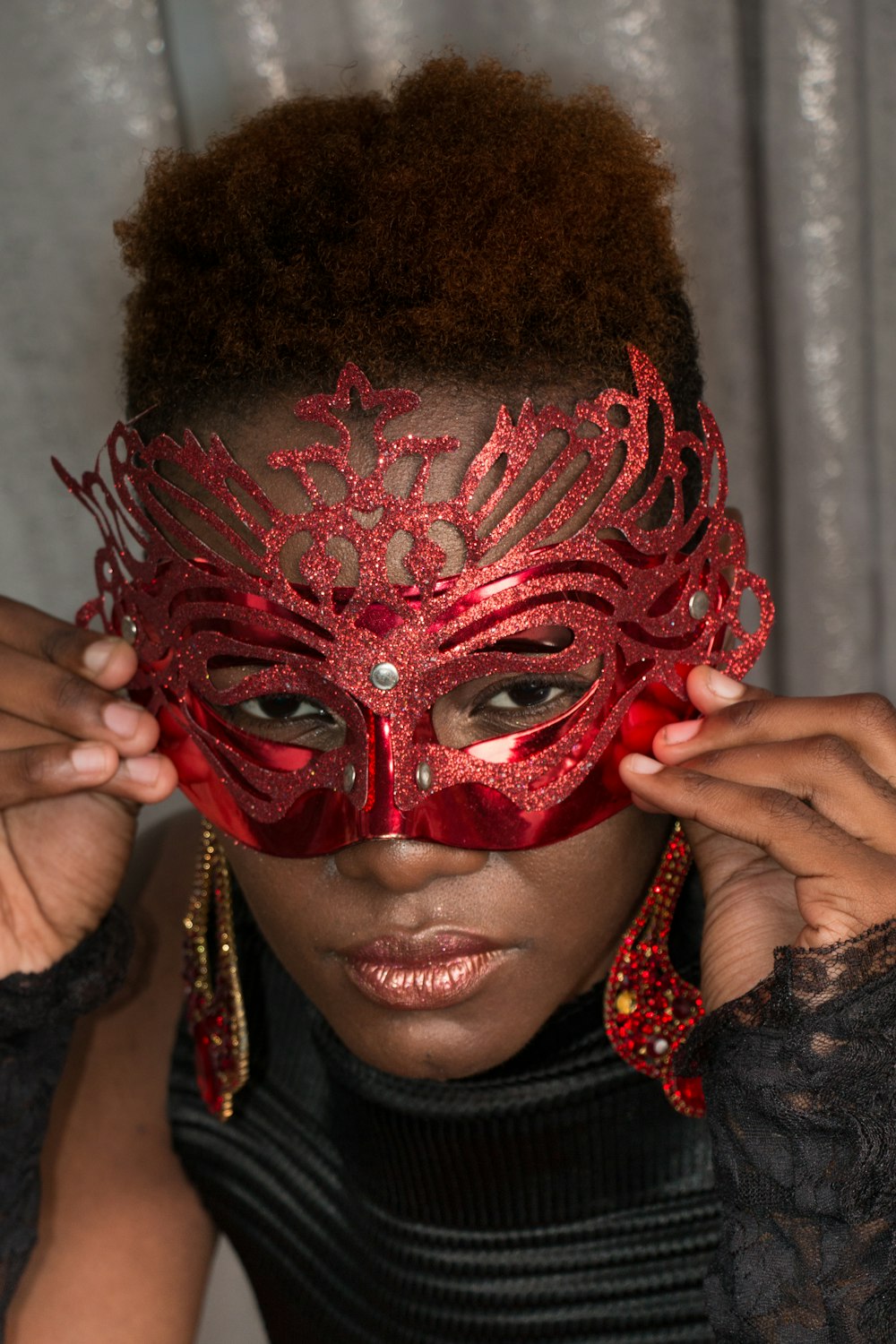 woman wearing red glittered mask