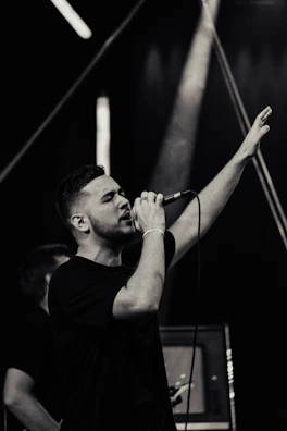 A tenor passionately performing a dramatic aria under warm stage lights.