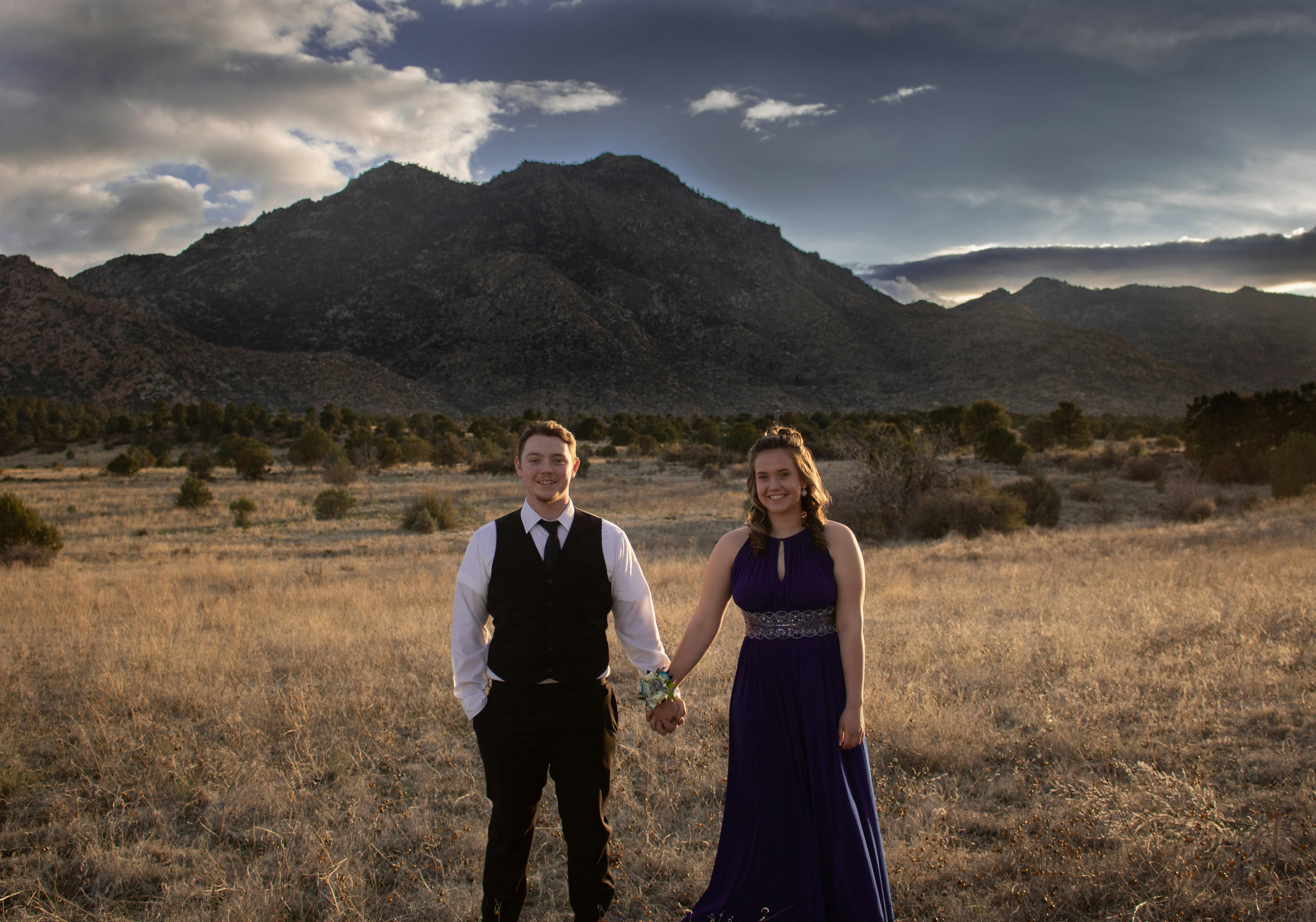 couple standing on grass field