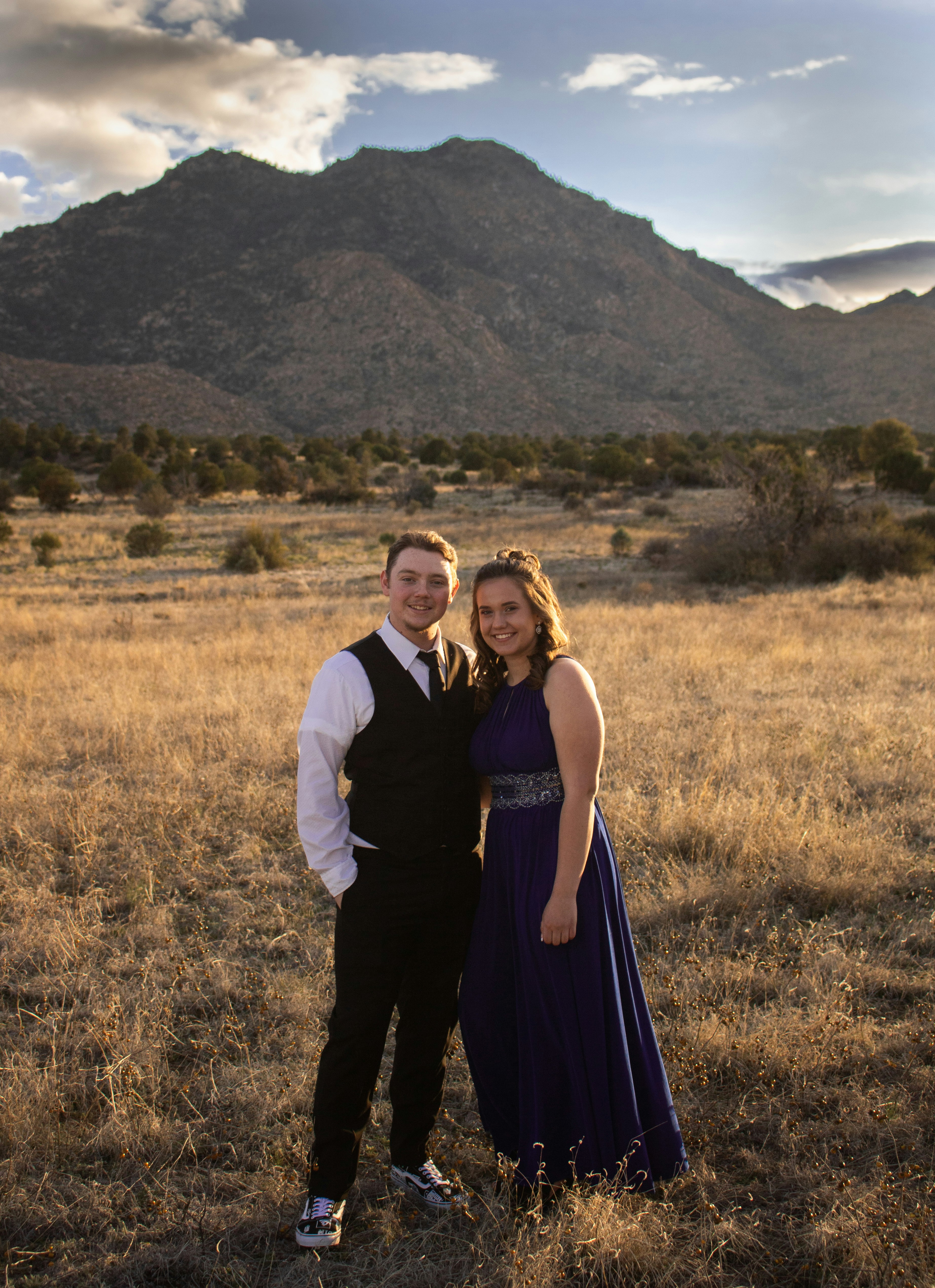 smiling man and woman on field