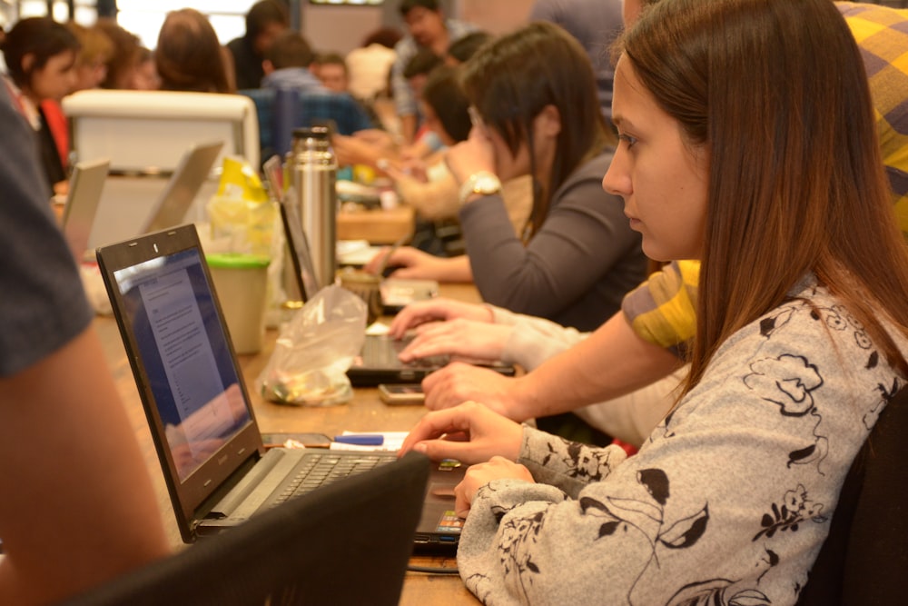 woman sitting and using laptop computer