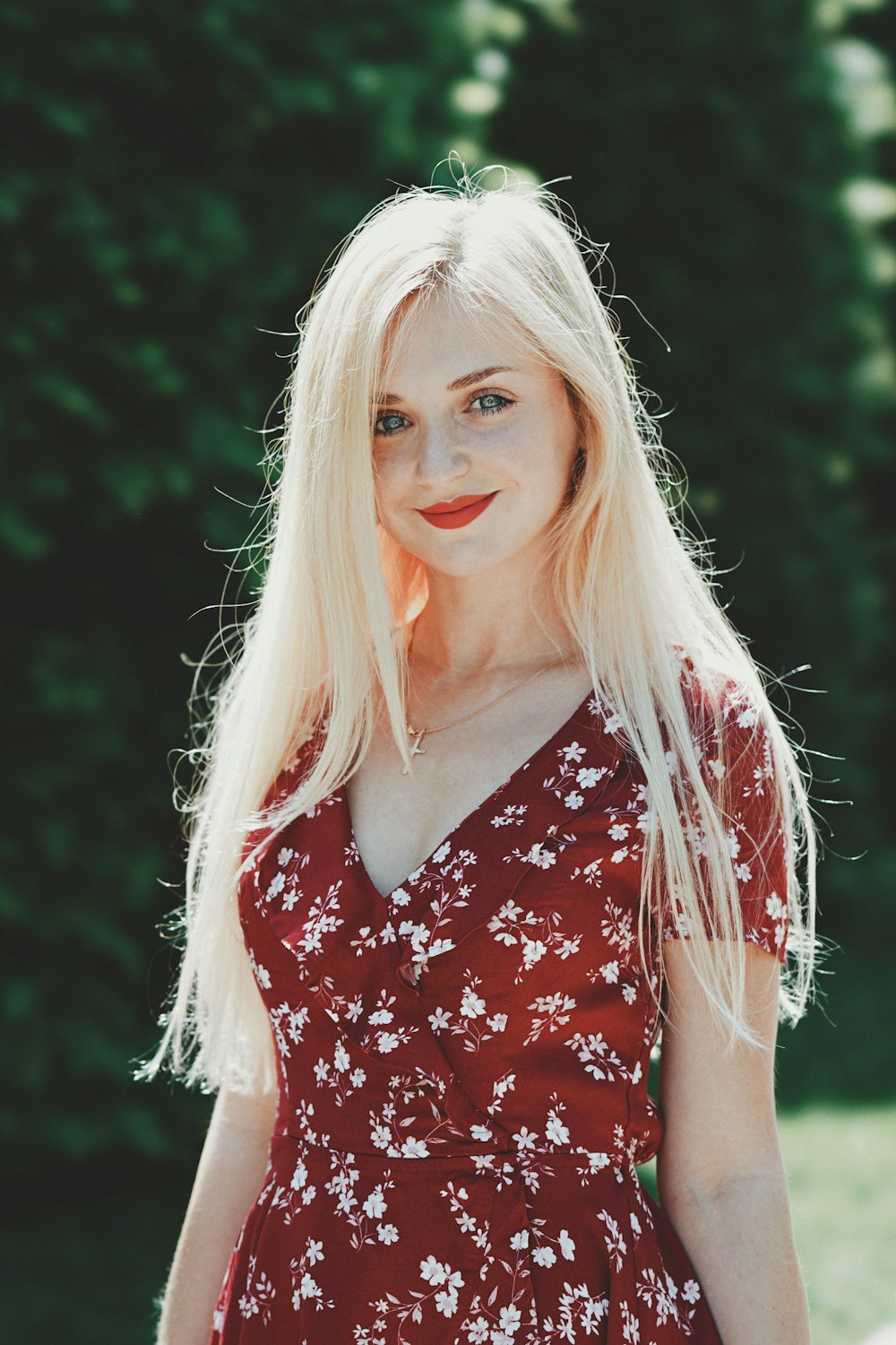 woman wearing red and white floral dress