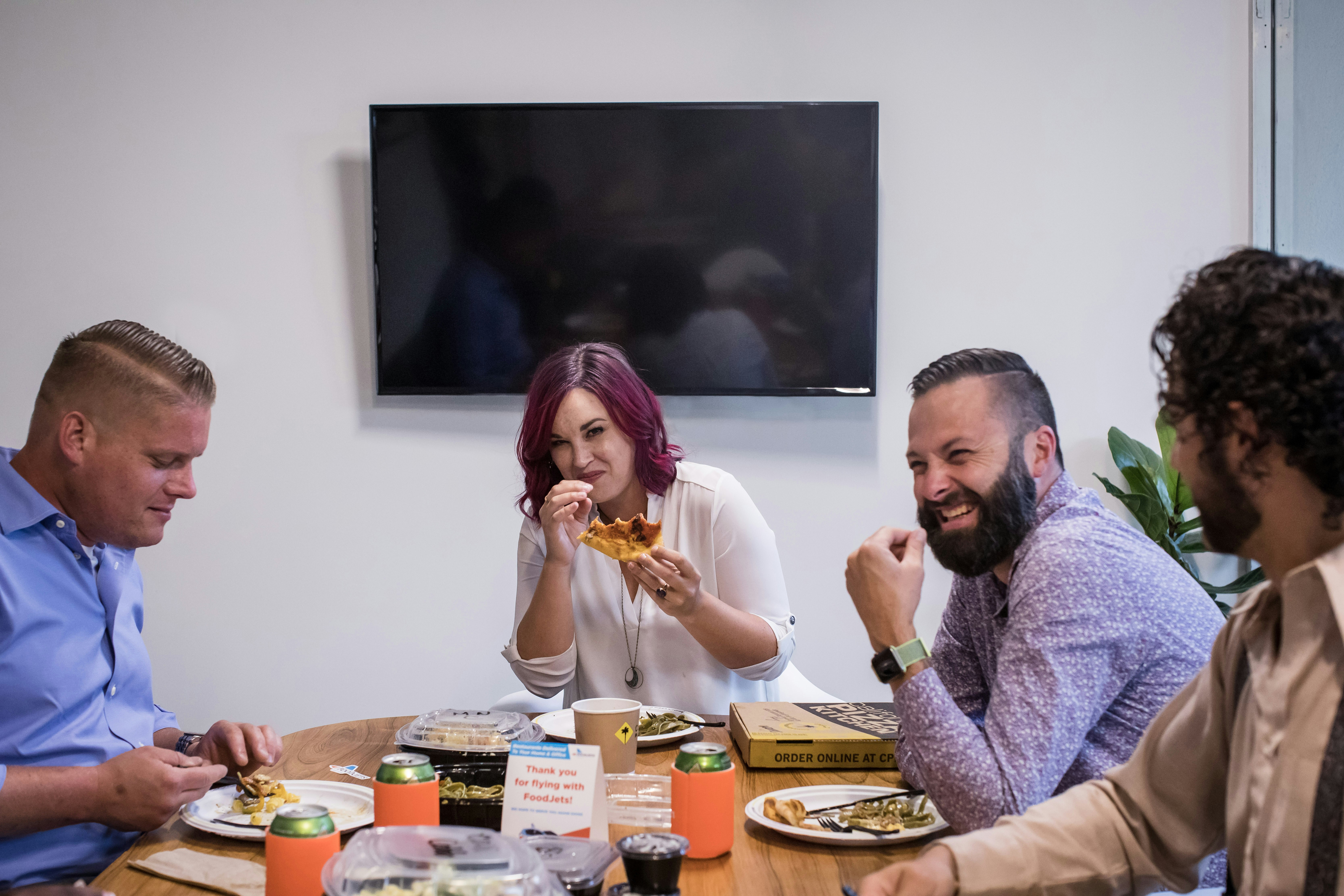 happy employees enjoying a catered lunch - catering business lunch