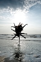Sunset over the Magdalena River with silhouettes of dancers practicing bullerengue on the shore.