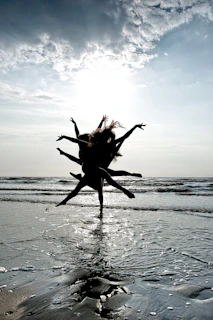 Silhouetted dancers performing at sunset outdoors, highlighting graceful lines