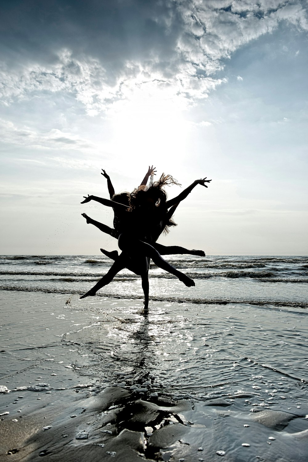 people dancing near seashore