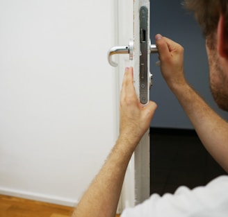 person holds door lever