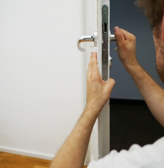 person holds door lever