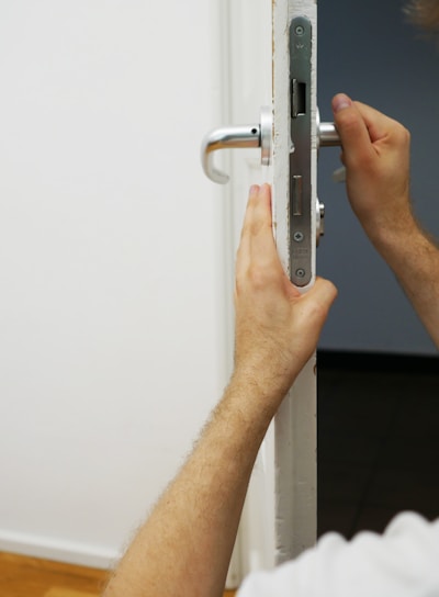 person holds door lever