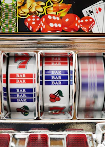 Close-up of colorful spinning slot reels with bright lights and symbols.