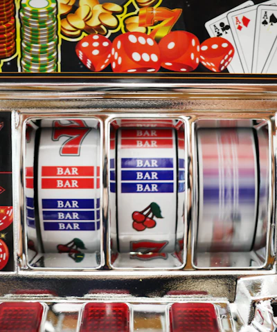 Close-up of colorful spinning slot reels with bright lights and symbols.