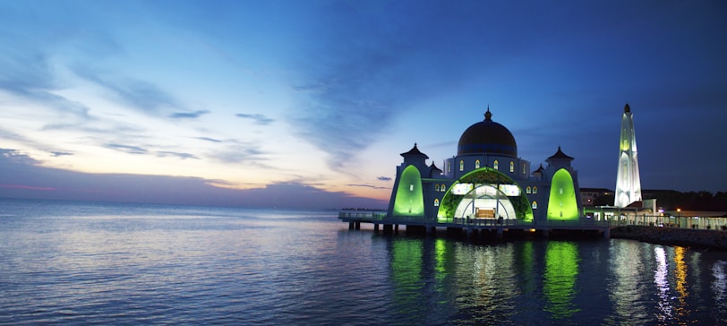 Evening view of Masjid Al Falaq glowing warmly under the twilight sky.