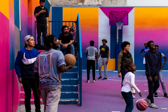 A vibrant sports facility with people enjoying various activities and a cozy restaurant area in the background.