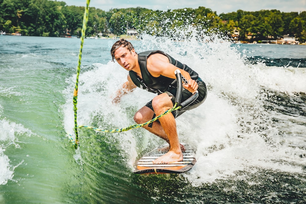 man wakeboarding on sea