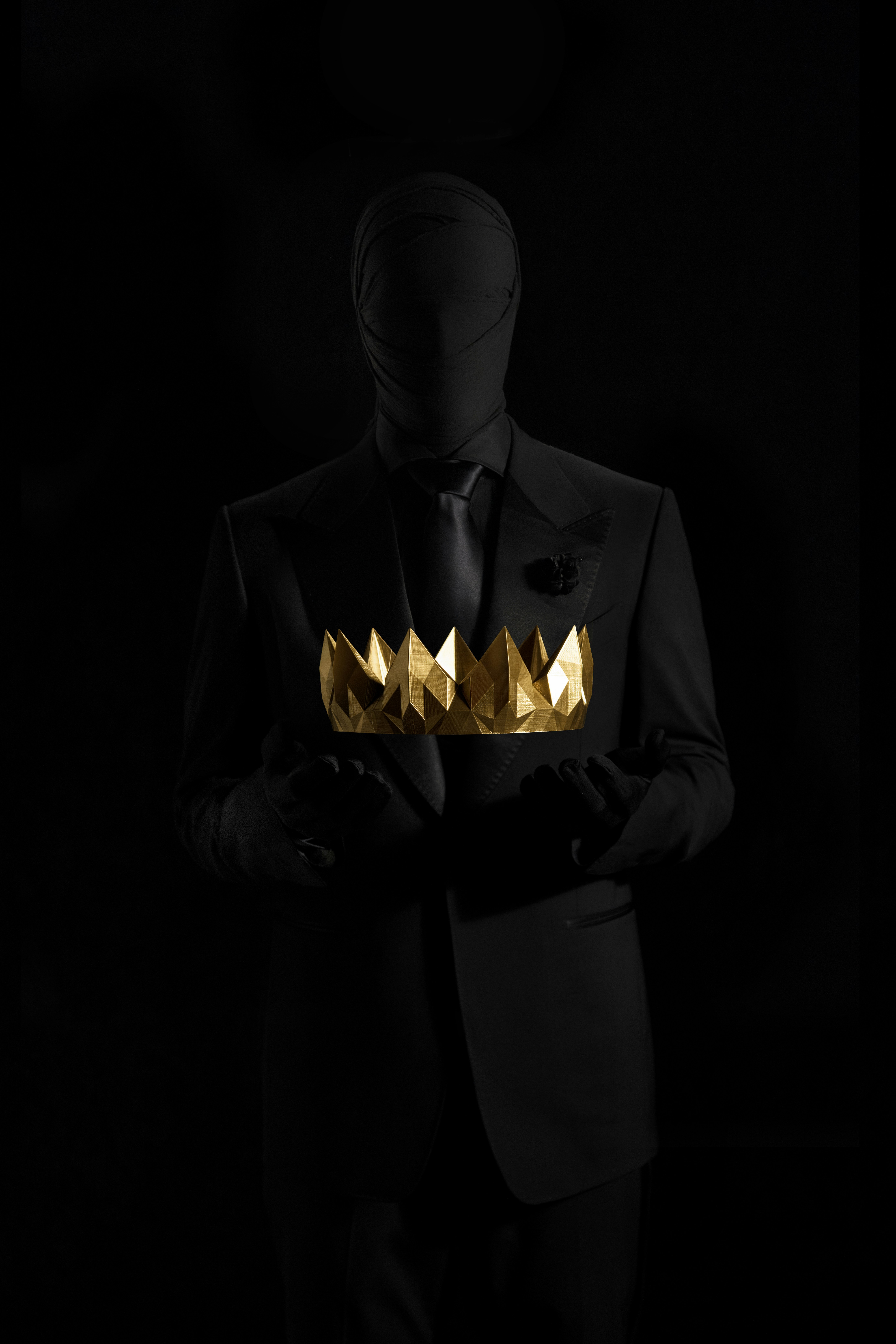 Silhouette holding gold crown