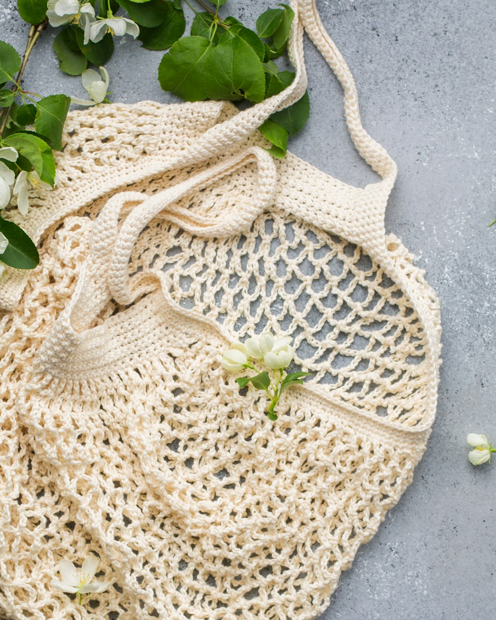 white knit tote bag on gray surface