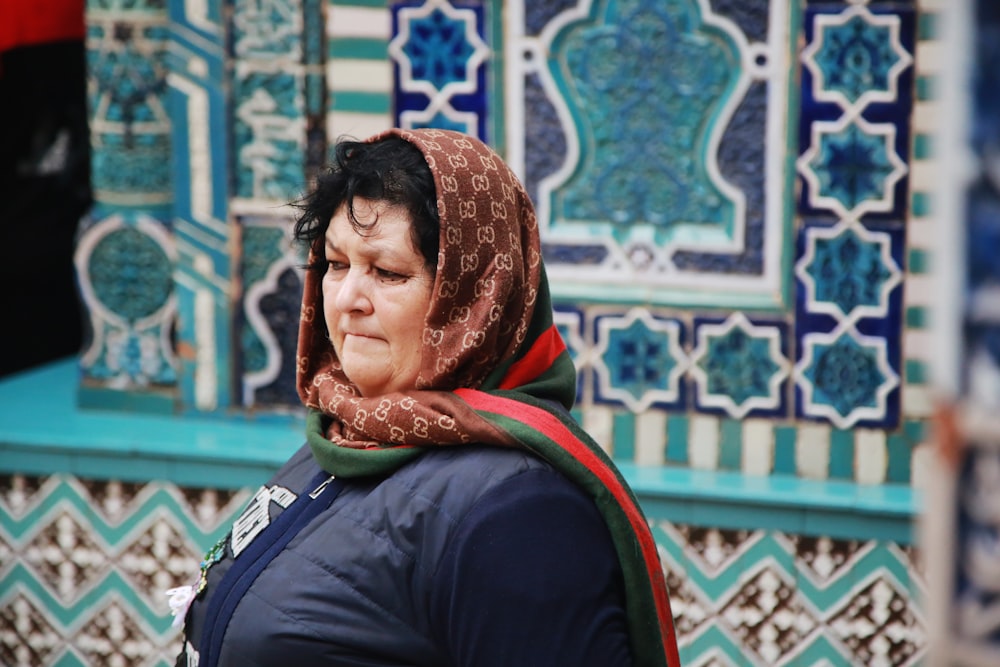 woman wearing brown, red, and green headscarf