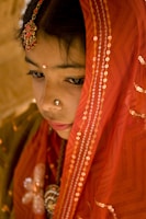 Portrait of a northeast Indian artisan in natural surroundings, bathed in warm, cinematic lighting.