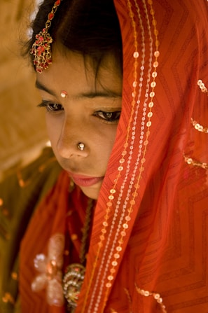 Portrait of a northeast Indian artisan in natural surroundings, bathed in warm, cinematic lighting.