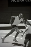 Women and girls playing tennis during the Lagos Ladies Open tournament on a sunny day.