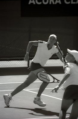 Women and girls playing tennis during the Lagos Ladies Open tournament on a sunny day.