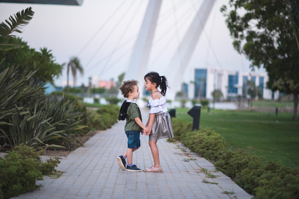 girl and boy standing on pathway